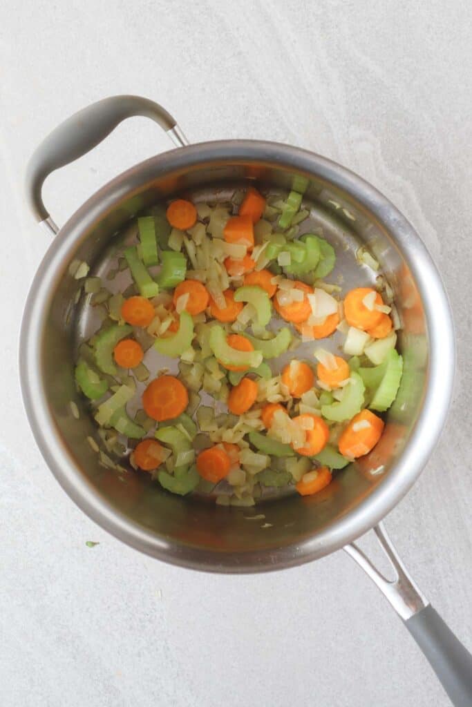 Carrots, celery, onions and garlic in large pot sautéed in olive oil