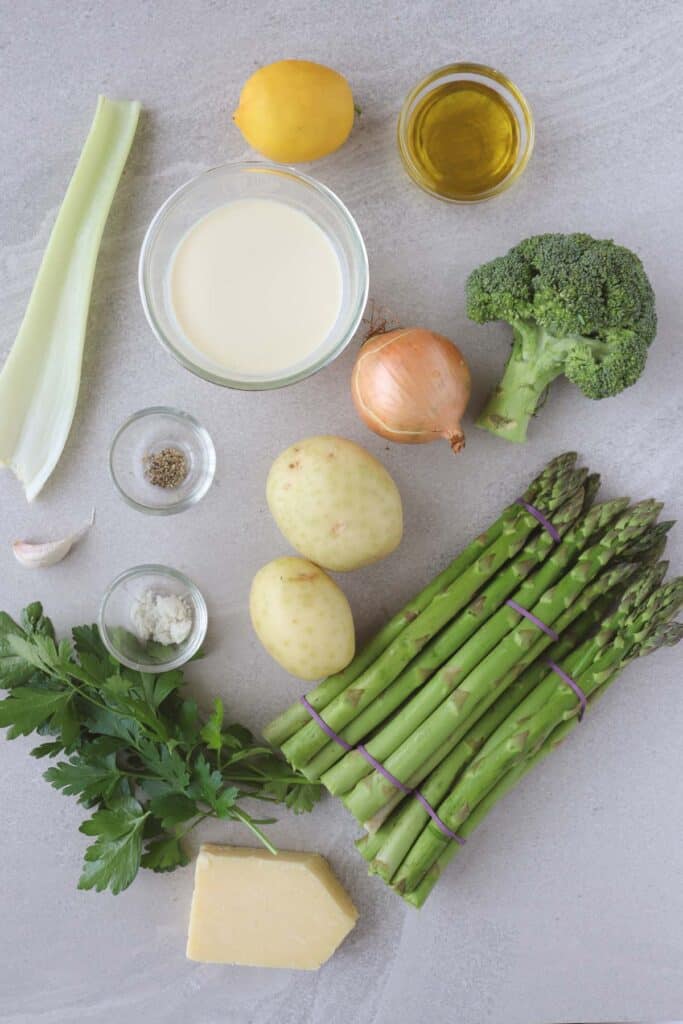 Ingredients including celery, lemon, olive oil, broccoli, asparagus, onion, potato, cheese, salt pepper, garlic, cream