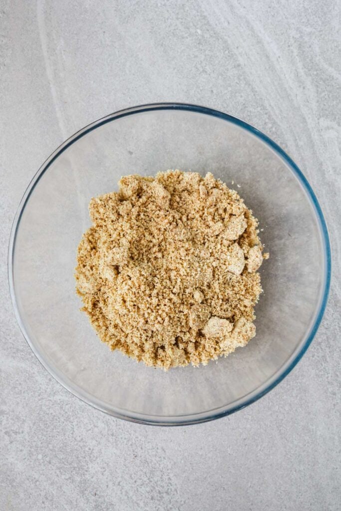 Ground cashews and almonds in a glass bowl