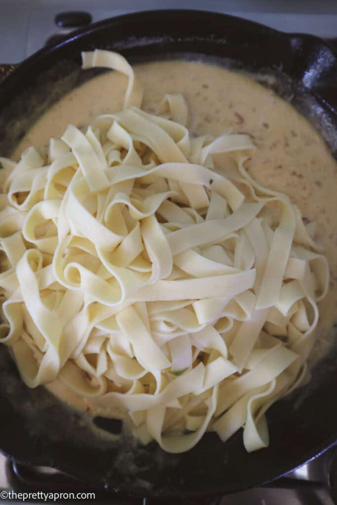 Pasta in skillet with alfredo sauce