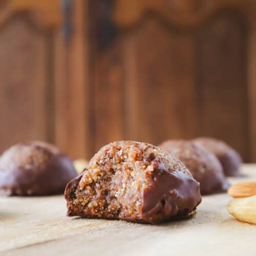 chocolate almond cashew balls on wooden board