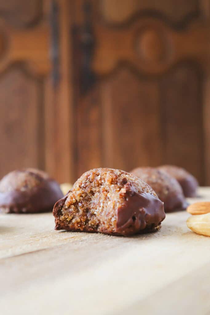 chocolate almond cashew balls on wooden board