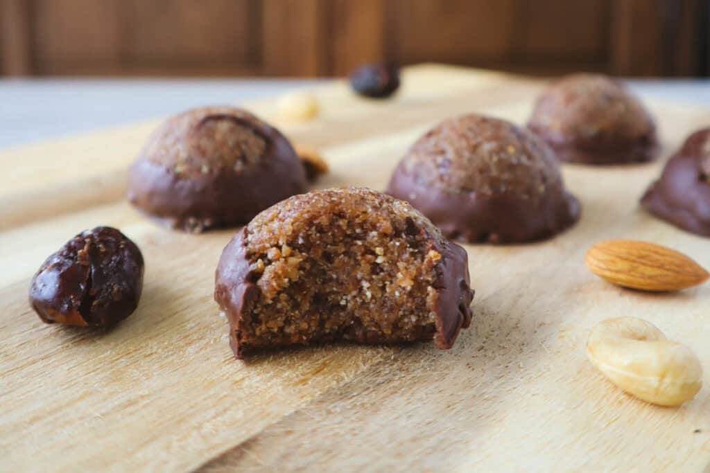 cashew almond chocolate balls on wooden board