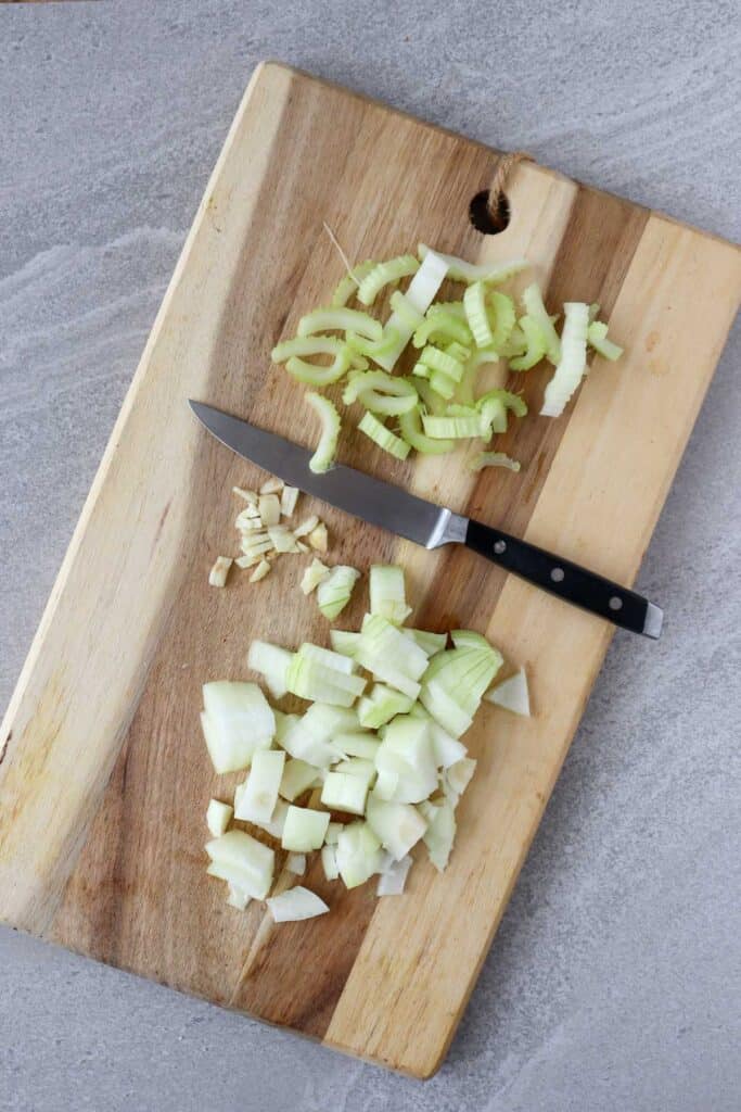 chopped onion, celery and garlic on cutting board