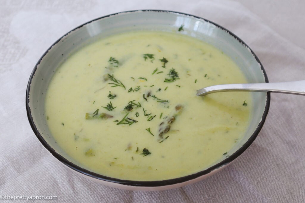 Bowl of creamy asparagus soup with dill