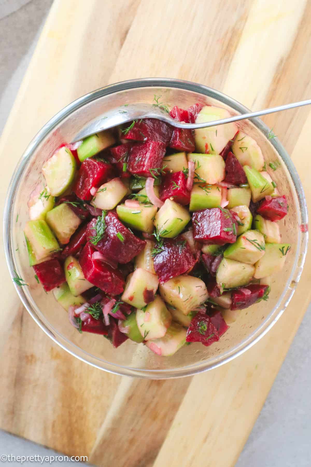 Cucumber beet salad in glass bowl