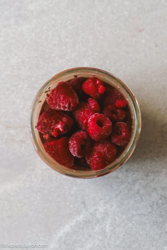 Jam jar with oats, cacao, chia seeds and milk