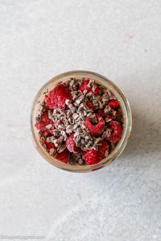 overhead shot of overnight chocolate raspberry oats with cacao nibs