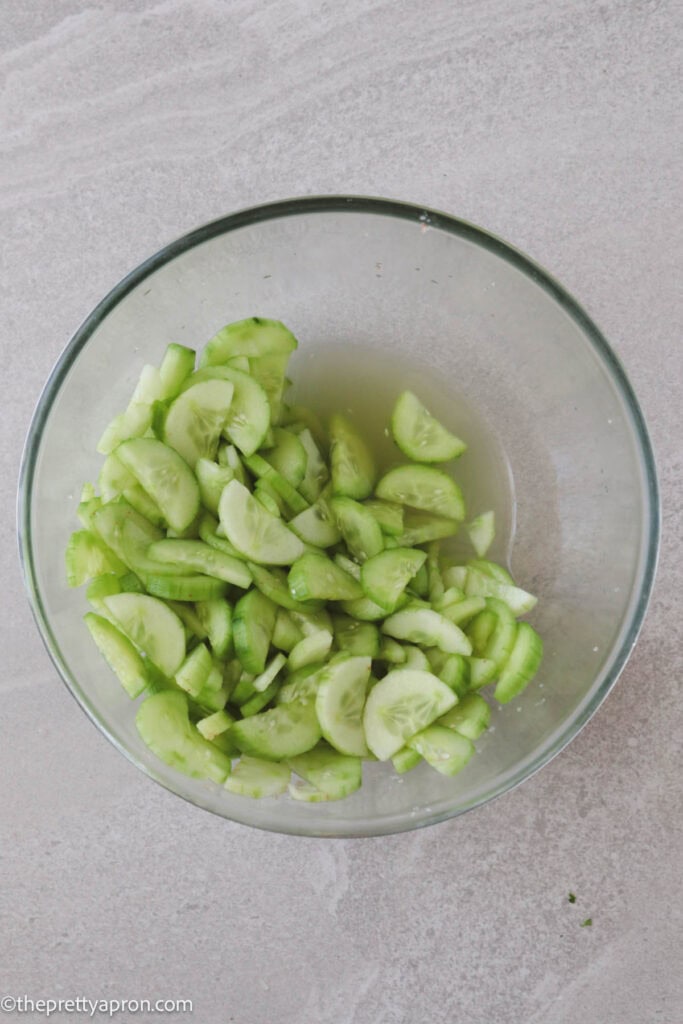 Cucumbers in bowl with excess water