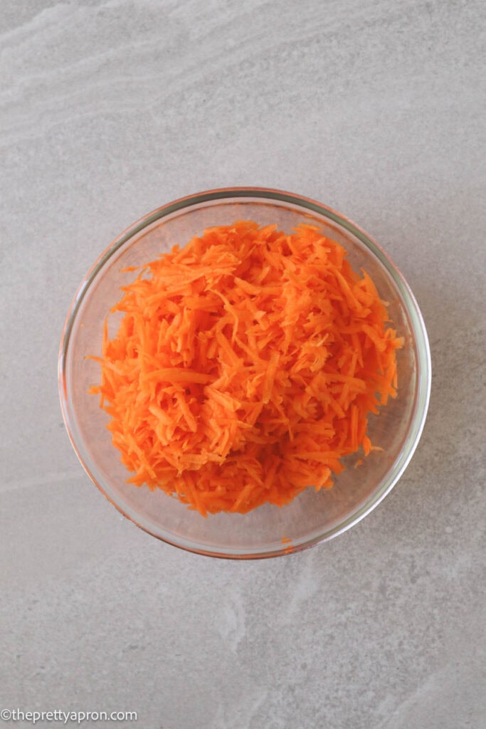 Grated carrots in a glass bowl.