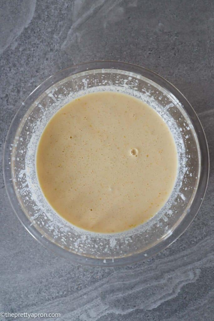 Wet ingredients for lemon ricotta blueberry pancakes in a glass bowl