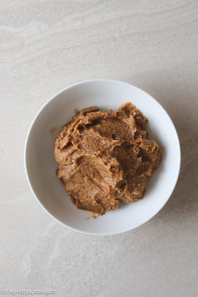 ground cashews and dates in small white bowl