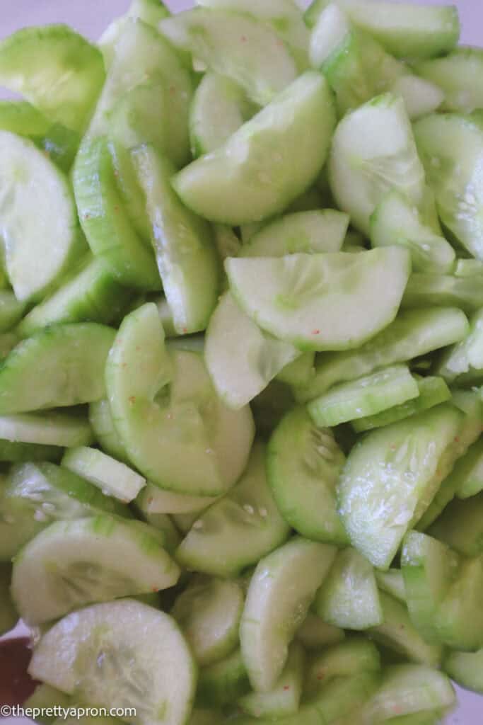 Salted sliced cucumbers in a bowl