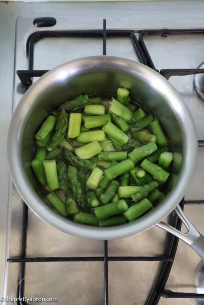 Chopped asparagus boiling in water