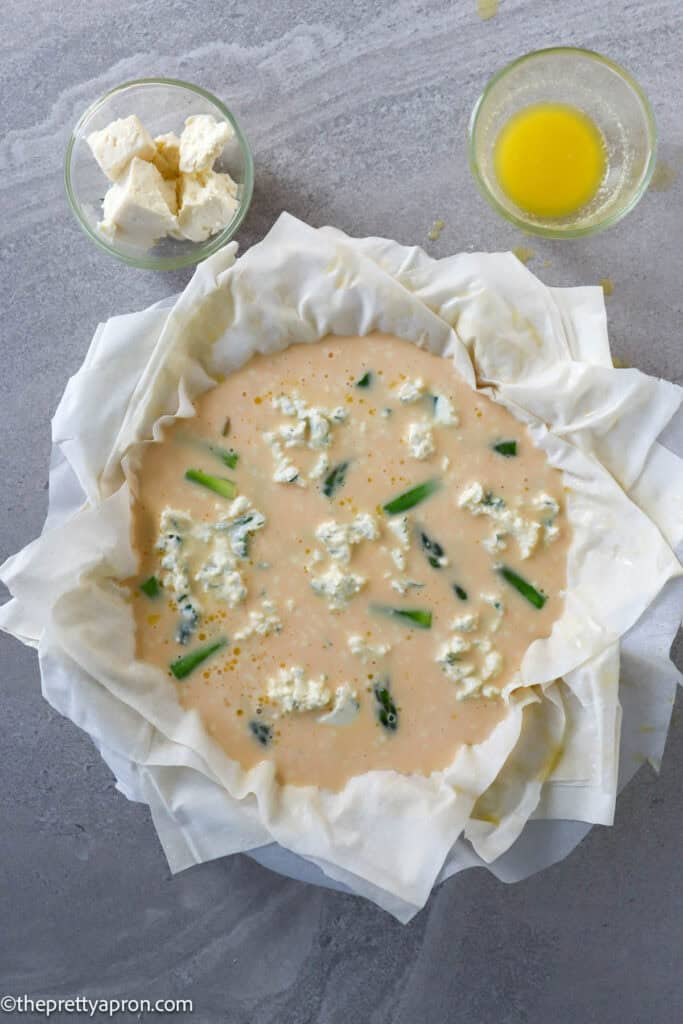 Phyllo dough in quiche dish filled with asparagus, ricotta cheese and eggs