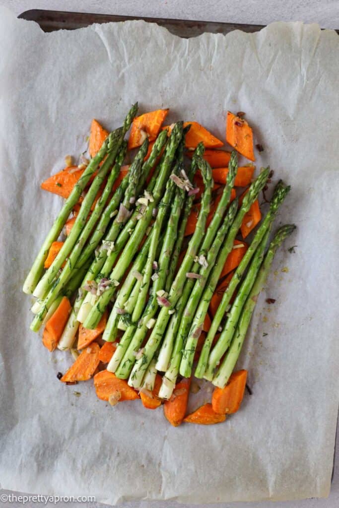 Asparagus placed on partially roasted carrots